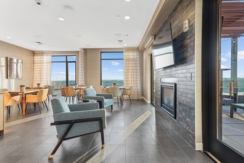 a living room with a fireplace and tables and chairs