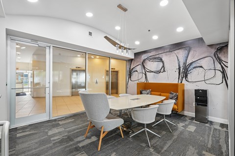A conference room with a large table and chairs.