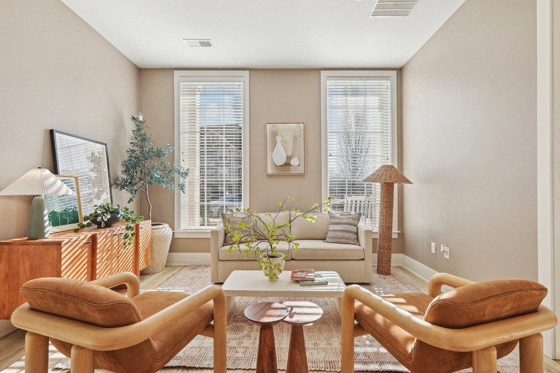 A living room with a couch, chair, and table.