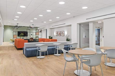 A modern office space with a wooden floor and white walls.