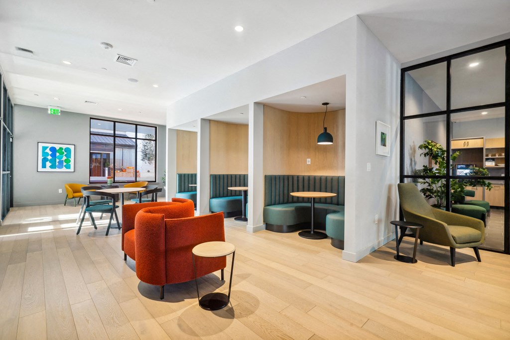 a lobby of a hotel with chairs and tables