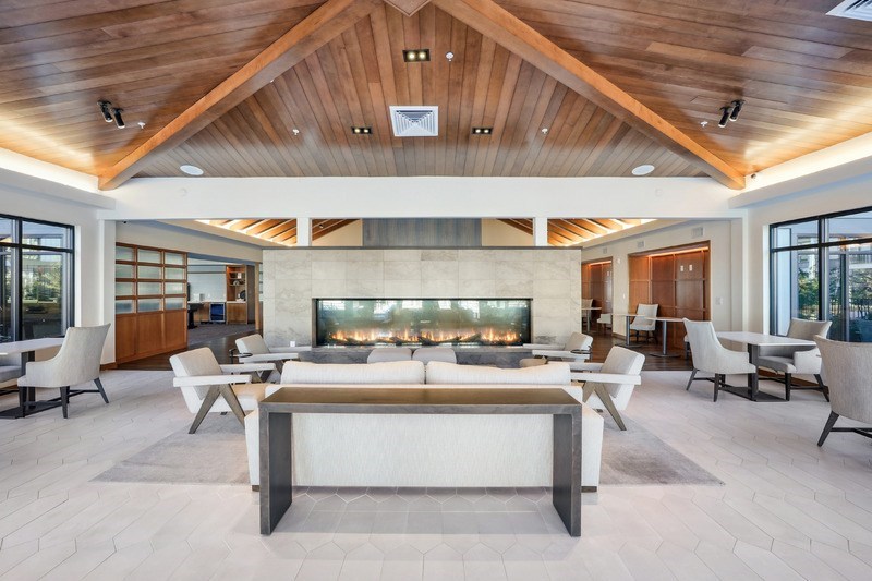 A modern living room with a fireplace and a large couch.