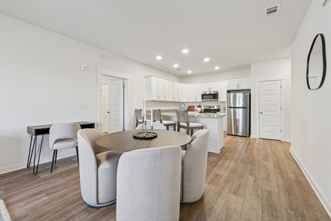 A modern dining room with a table set for six.