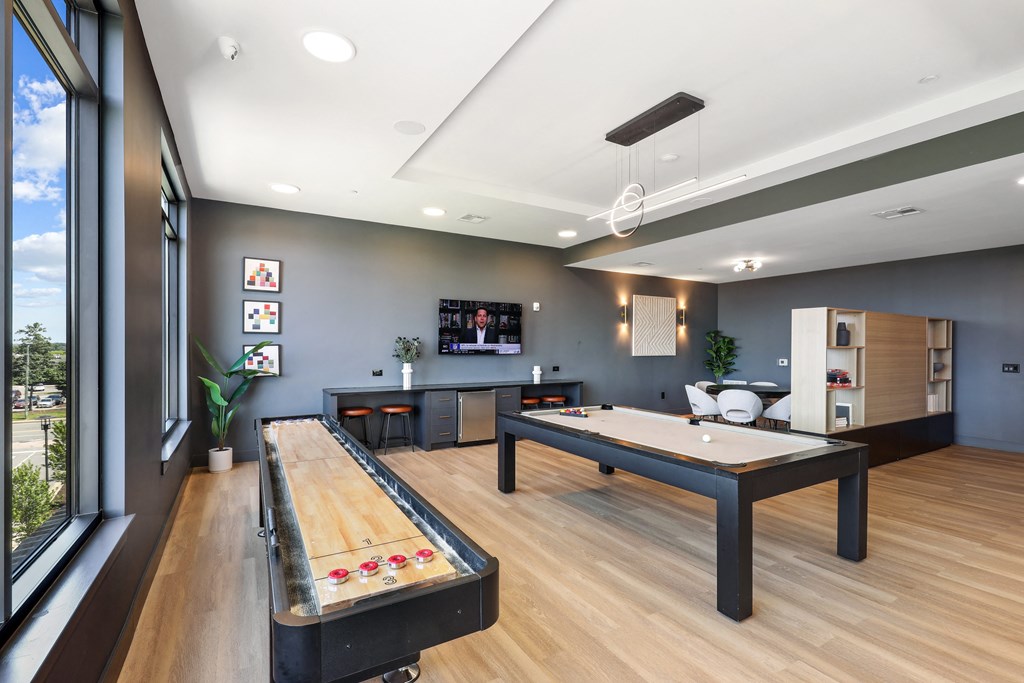 a game room with a pool table and a television