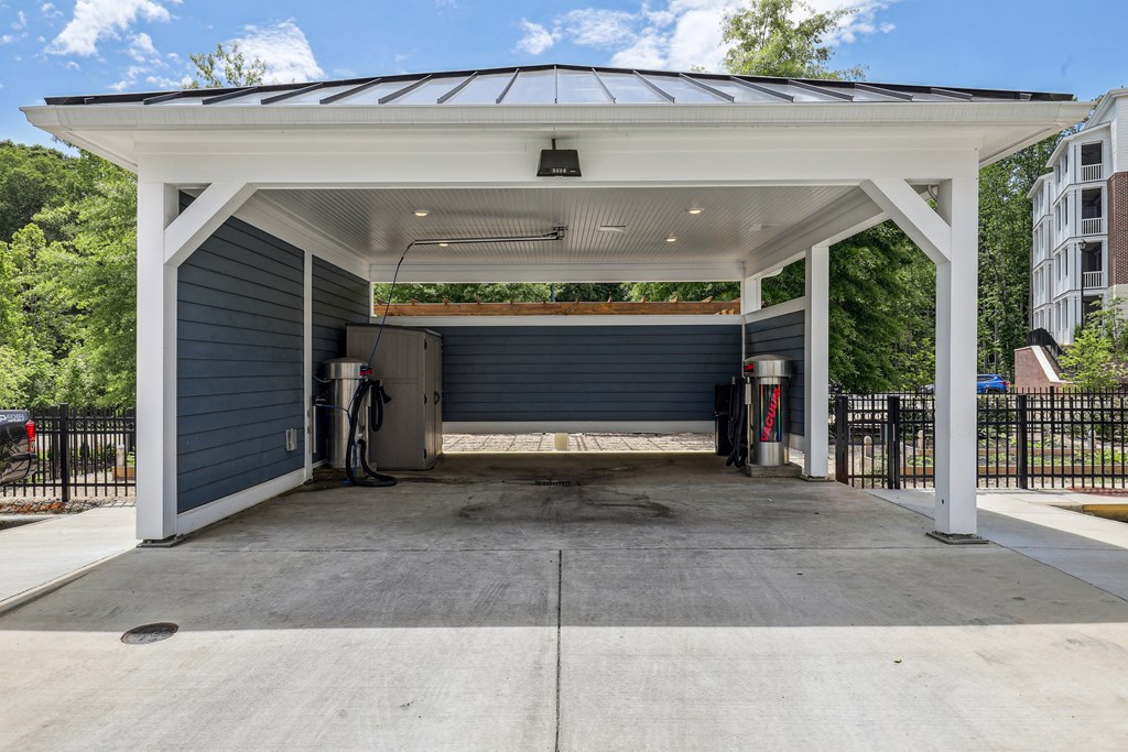 a gas station with a black garage door