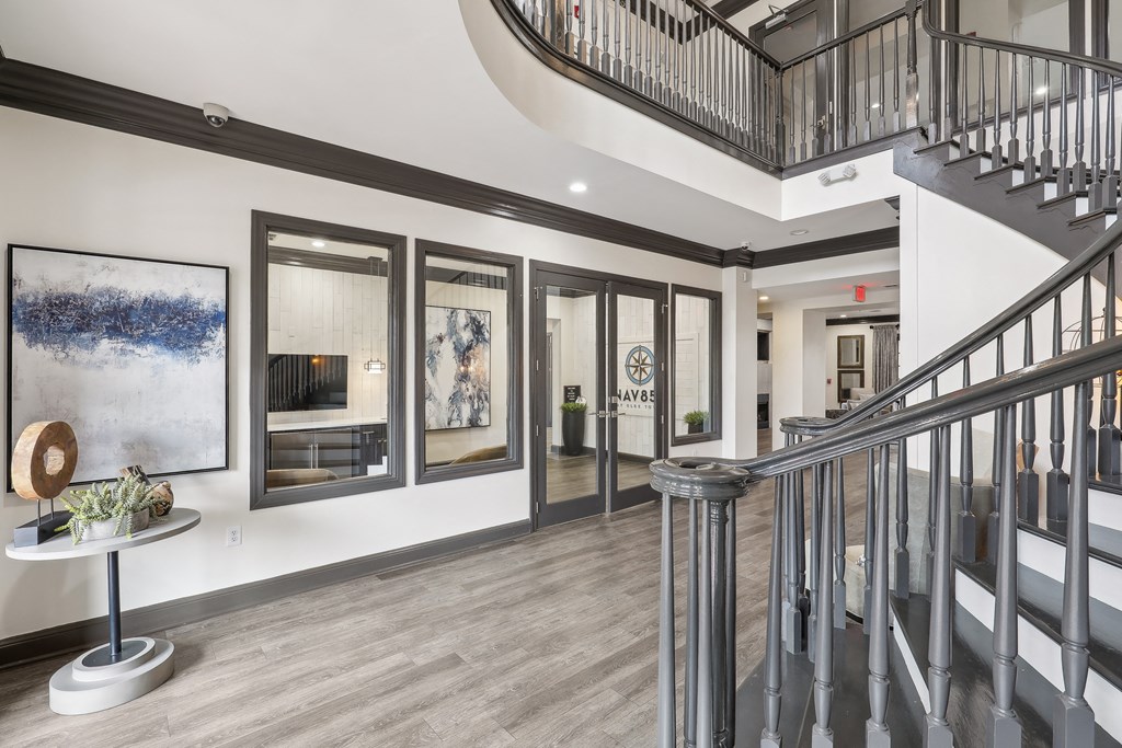 the landing of a staircase in a house with paintings on the wall