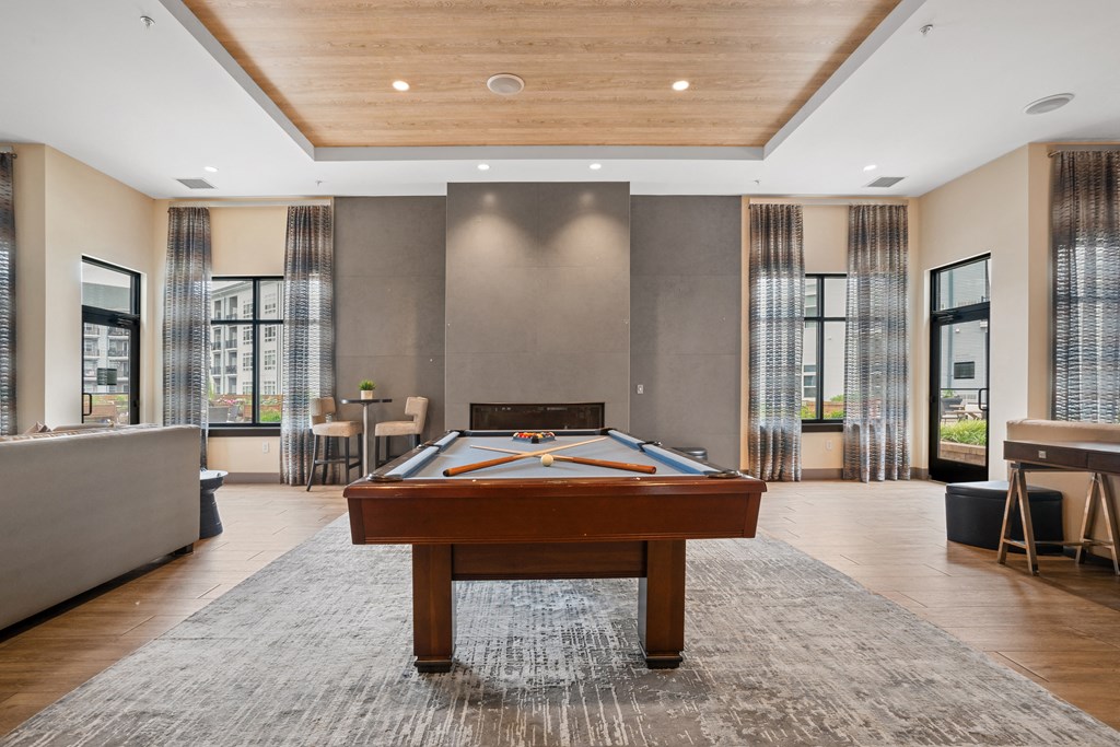 a room with a pool table in the middle of it