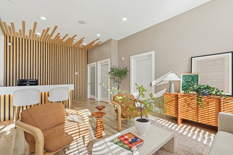 A living room with a brown chair and a white table.