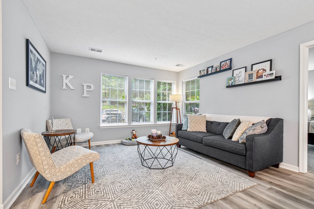 A living room with a grey couch, a chair, and a coffee table.