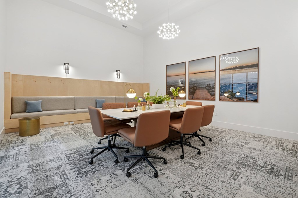 A conference room with a long table and chairs.