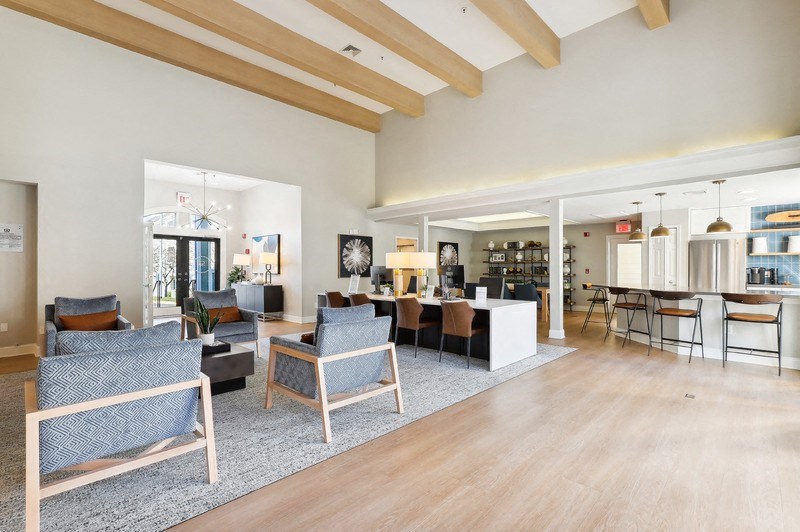 a large living room with furniture and a kitchen