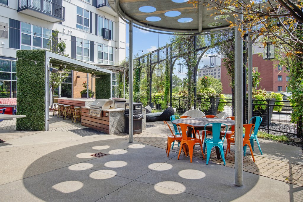 A patio with a table and chairs under a canopy.