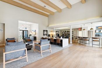 a large living room with furniture and a kitchen