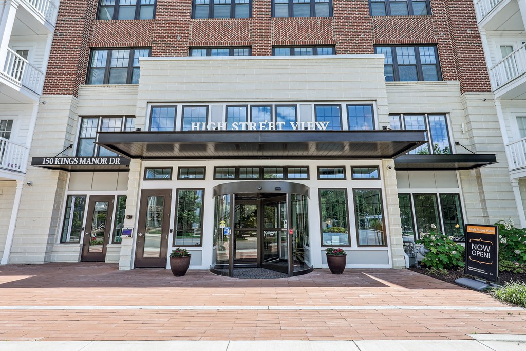 the front entrance of a building with a revolving door