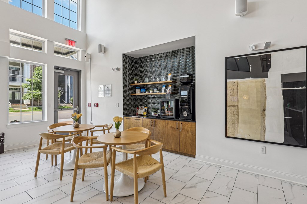 a dining area with tables and chairs and a bar in the corner of a building