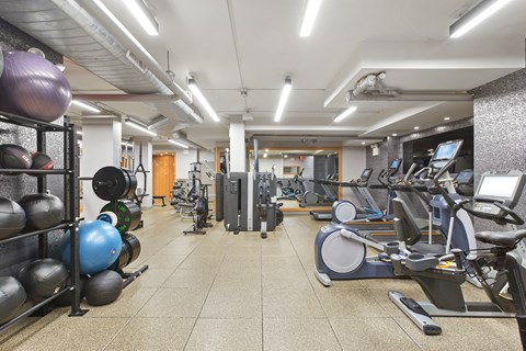 a gym with weights and other exercise equipment on a tiled floor