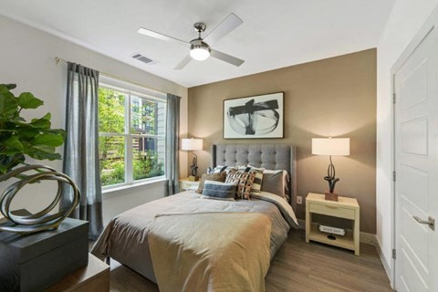 a bedroom with a bed and a ceiling fan