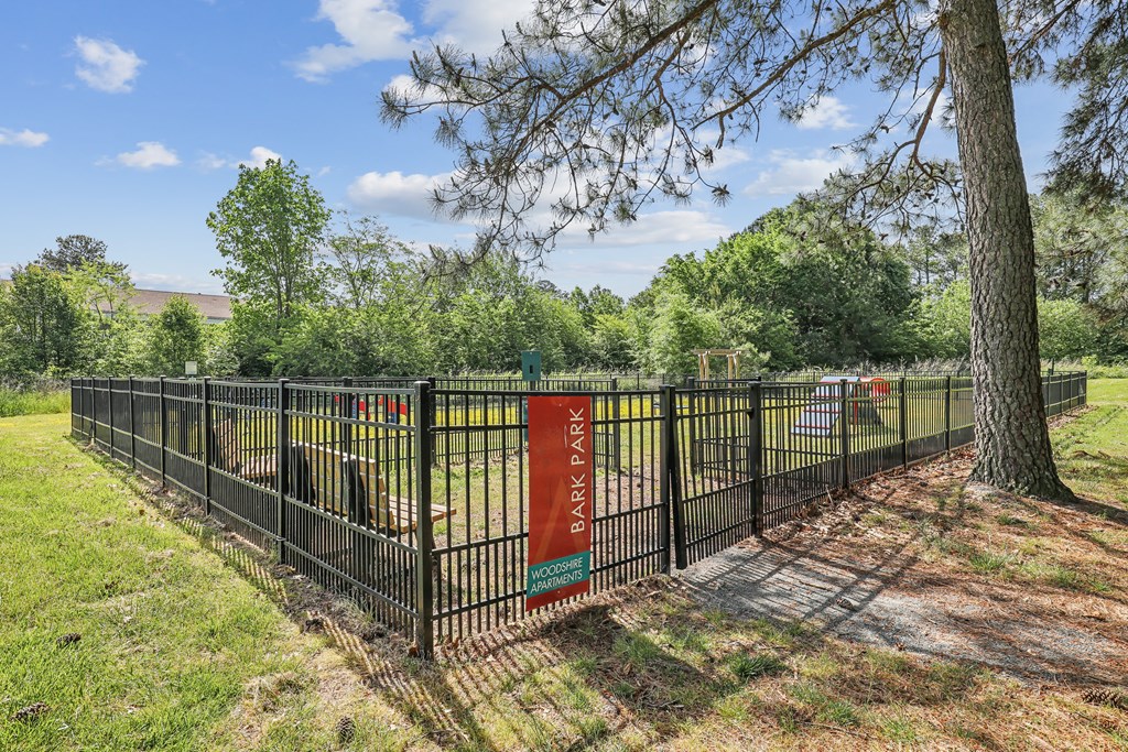 a park with a fence and a tree