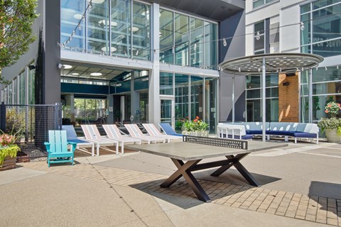 A sunny day at the outdoor seating area of a modern building.