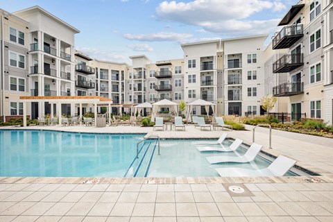a swimming pool in front of an apartment building