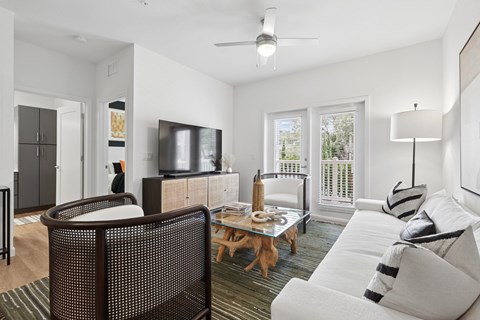 A living room with a white couch and a wooden coffee table.