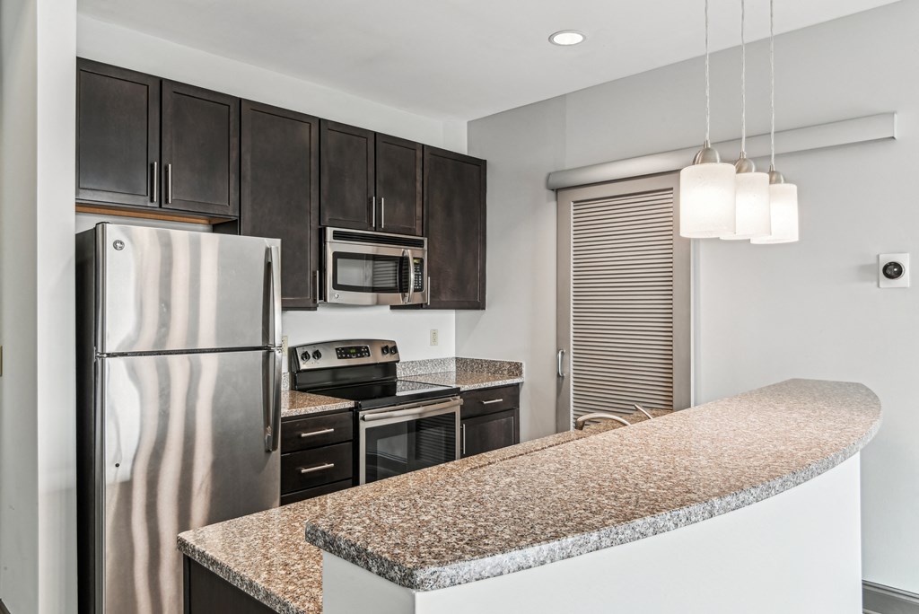 a kitchen with granite counter tops and stainless steel appliances