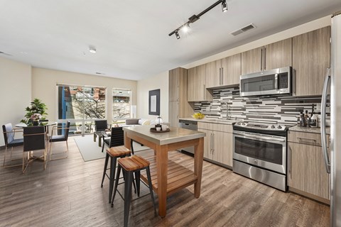 A modern kitchen with a dining table and chairs.