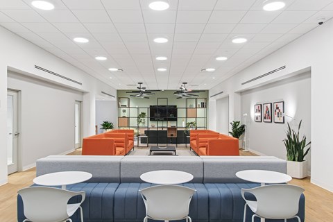 A conference room with a long table and chairs.