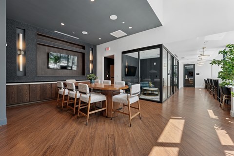 A modern dining room with a wooden table and chairs.