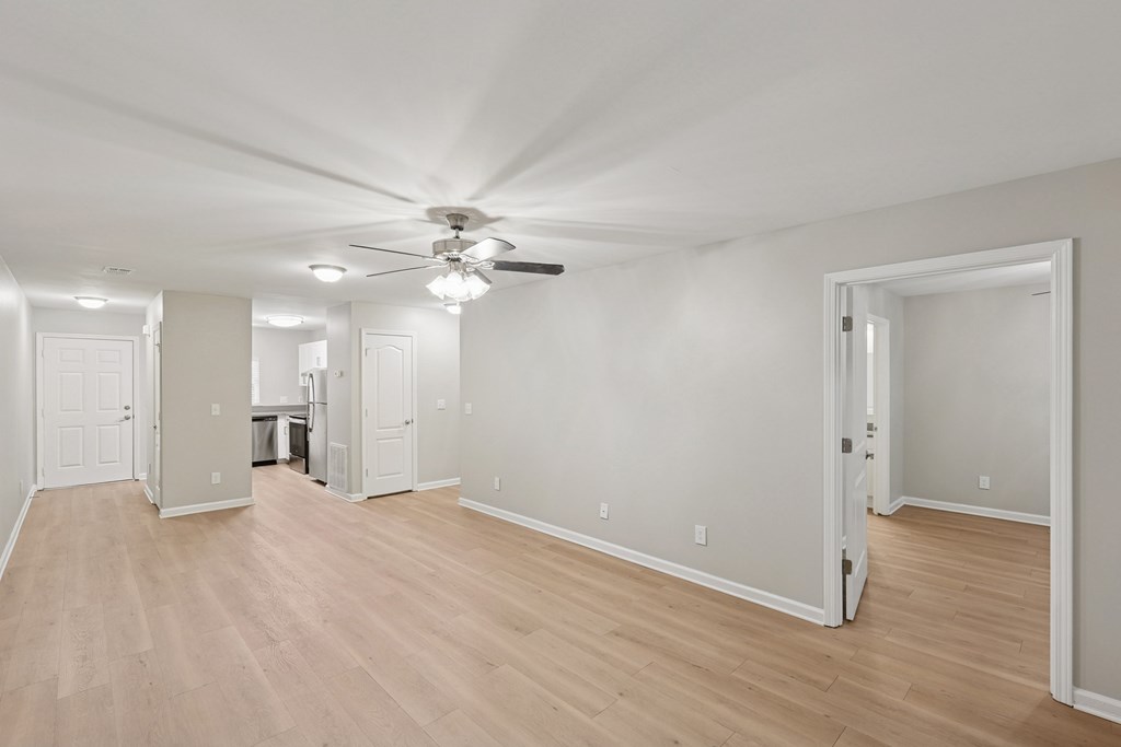 A room with a ceiling fan and lighting fixtures.