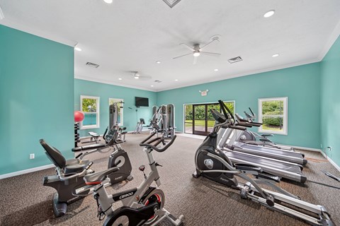 A spacious gym with a variety of exercise equipment.