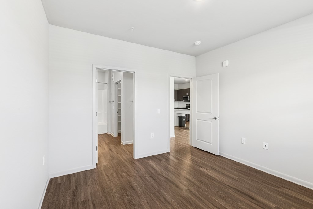 A room with white walls and wooden floors.