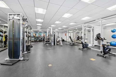 A spacious gym with various exercise equipment.