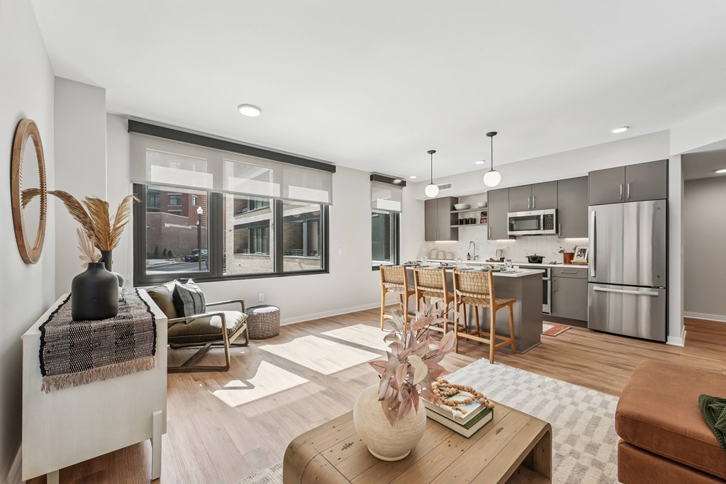 A modern kitchen with a dining area and a living room.