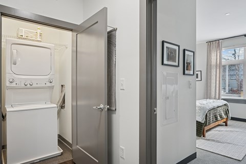 A small kitchen with a refrigerator and oven built into a wall.