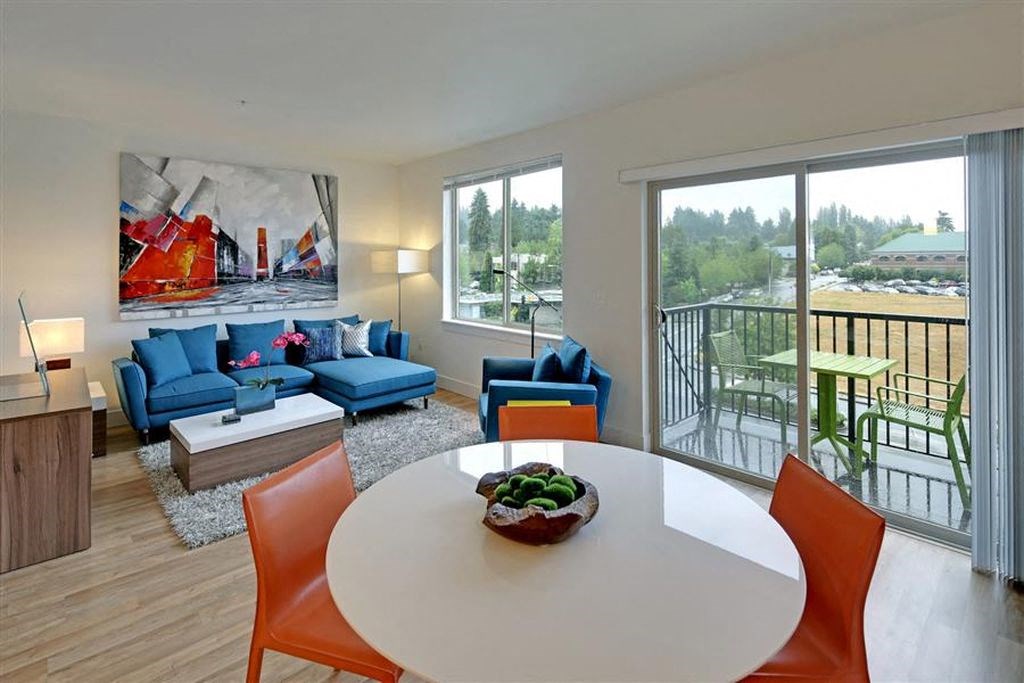 a living room with a white table and chairs