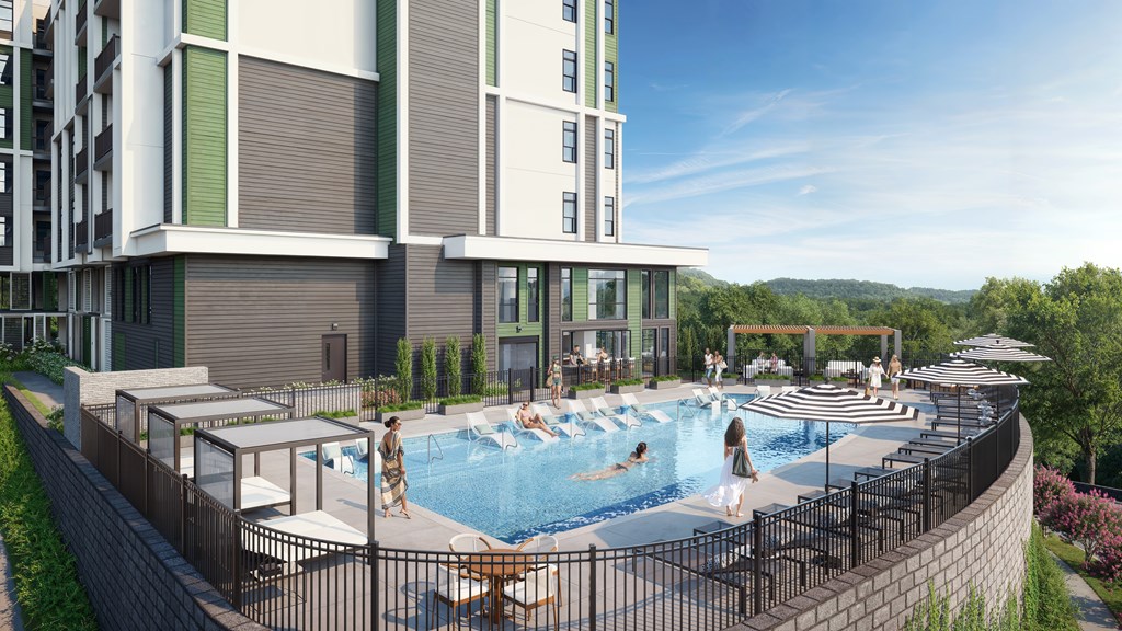 A modern building with a pool and people enjoying the sun.