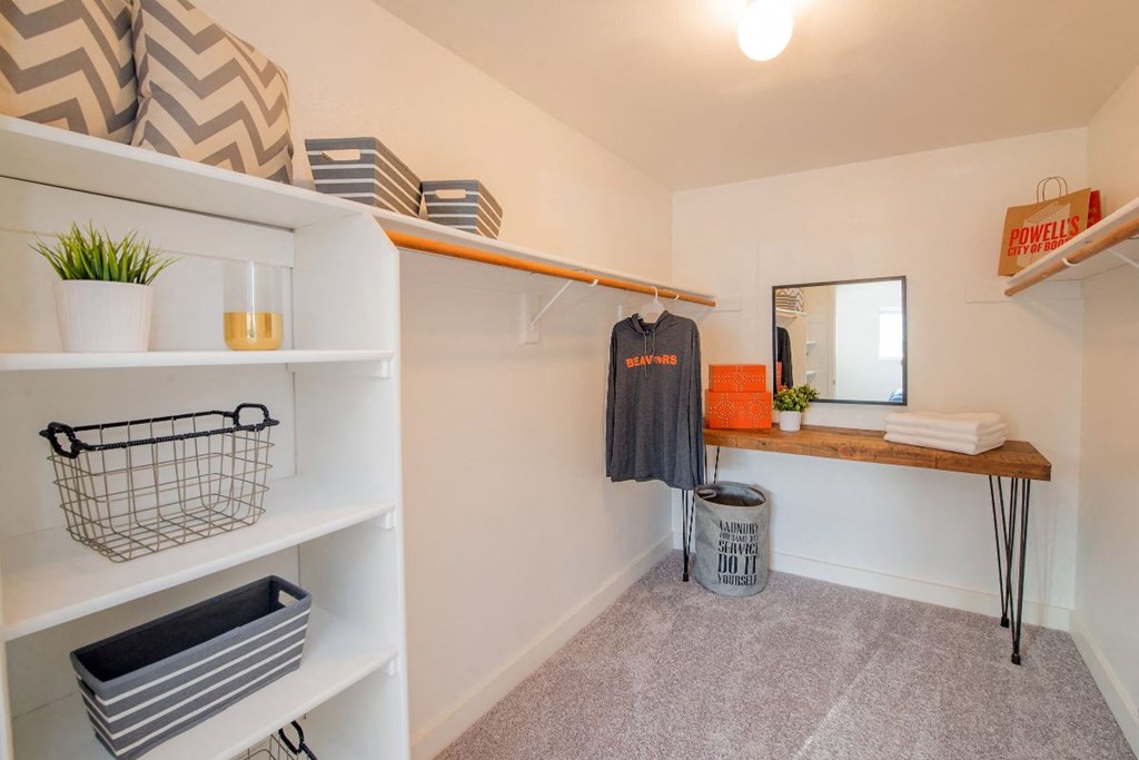 a walk in closet with white walls and a wooden shelf at The Arden Apartments, Oregon, 97080