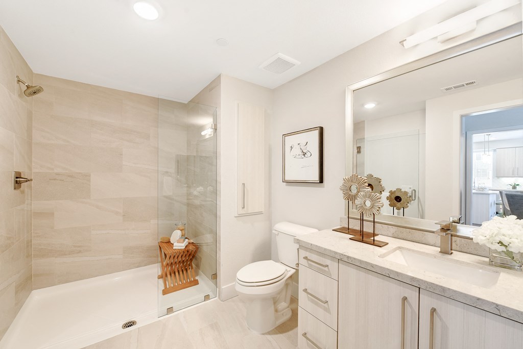 White bathroom with a shower at Sola, San Diego, CA