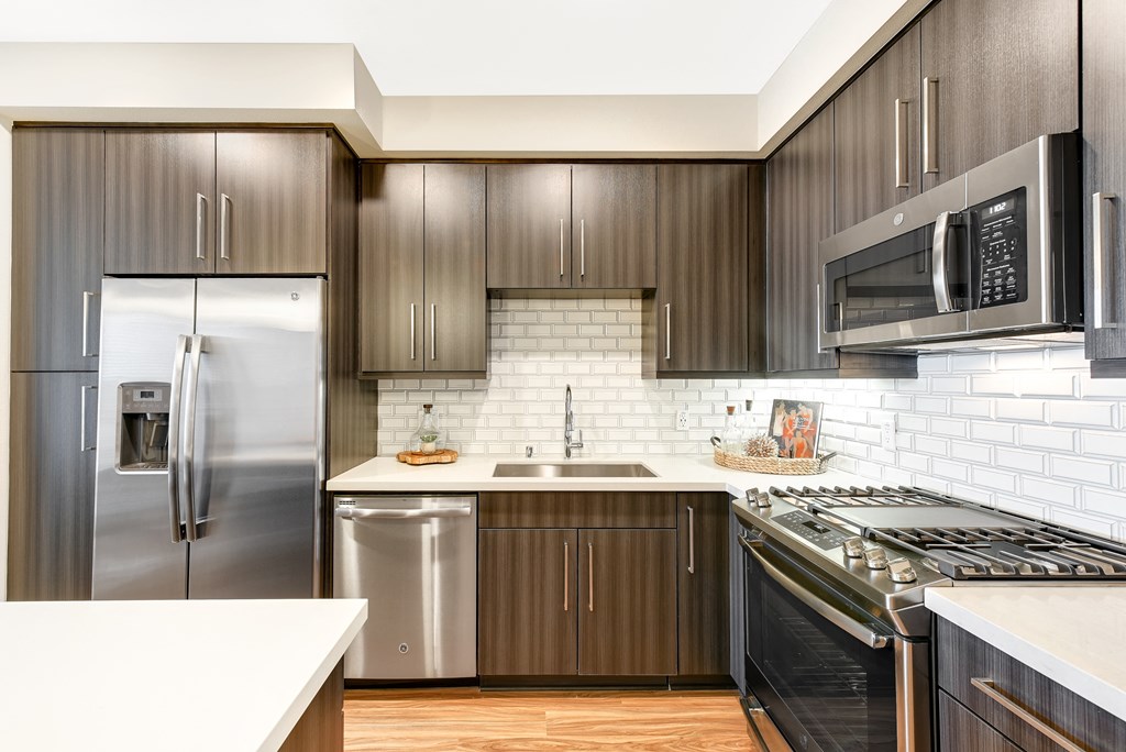 Kitchen with stainless steel appliances and wooden cabinets at Sola, California, 92130