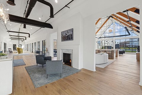 a large living room with a fireplace and a large window