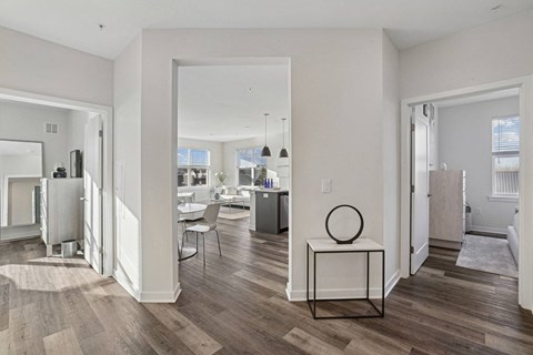 a living room with a view of a dining room and a kitchen