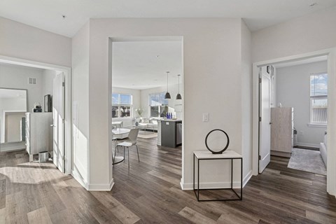 a living room with a view of a dining room and a kitchen
