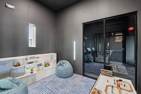the play room has a sliding glass door to the office