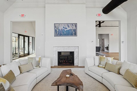 a living room with two couches and a coffee table and a fireplace