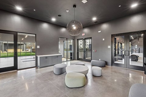 the lobby of a gym with seating and a disco ball