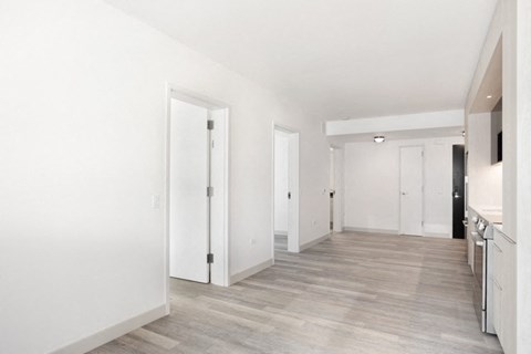 a bedroom with a medium hardwood floor and white walls