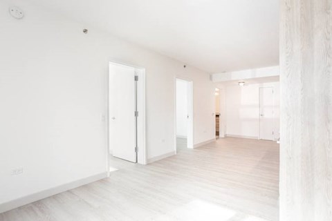 an empty room with white walls and white floors