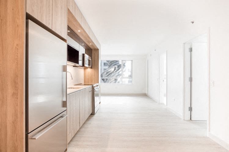 a kitchen with a stainless steel refrigerator freezer next to a stove top oven