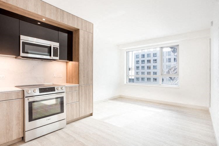 a kitchen with a stove top oven next to a window